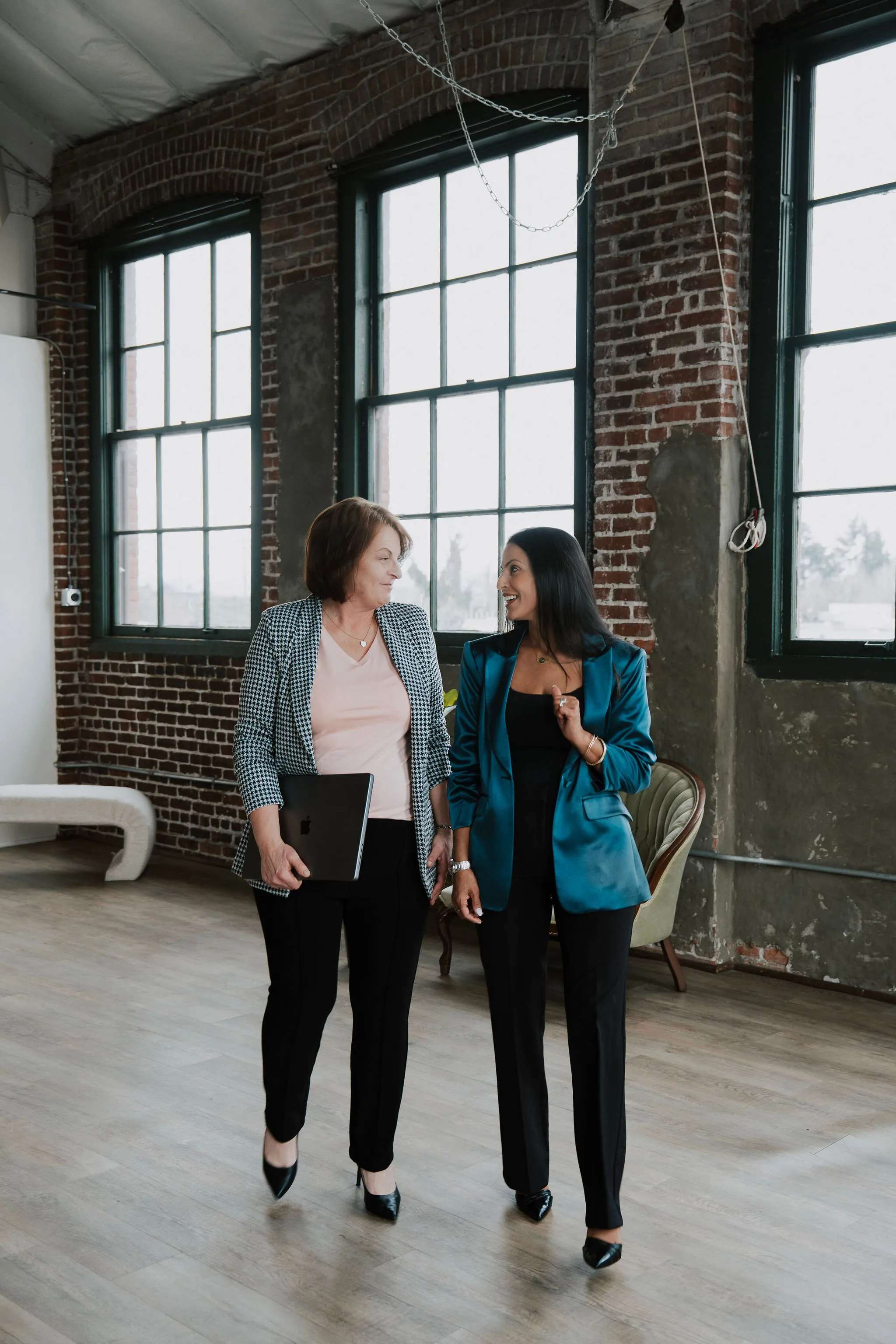 Two providers walking through a brick loft.